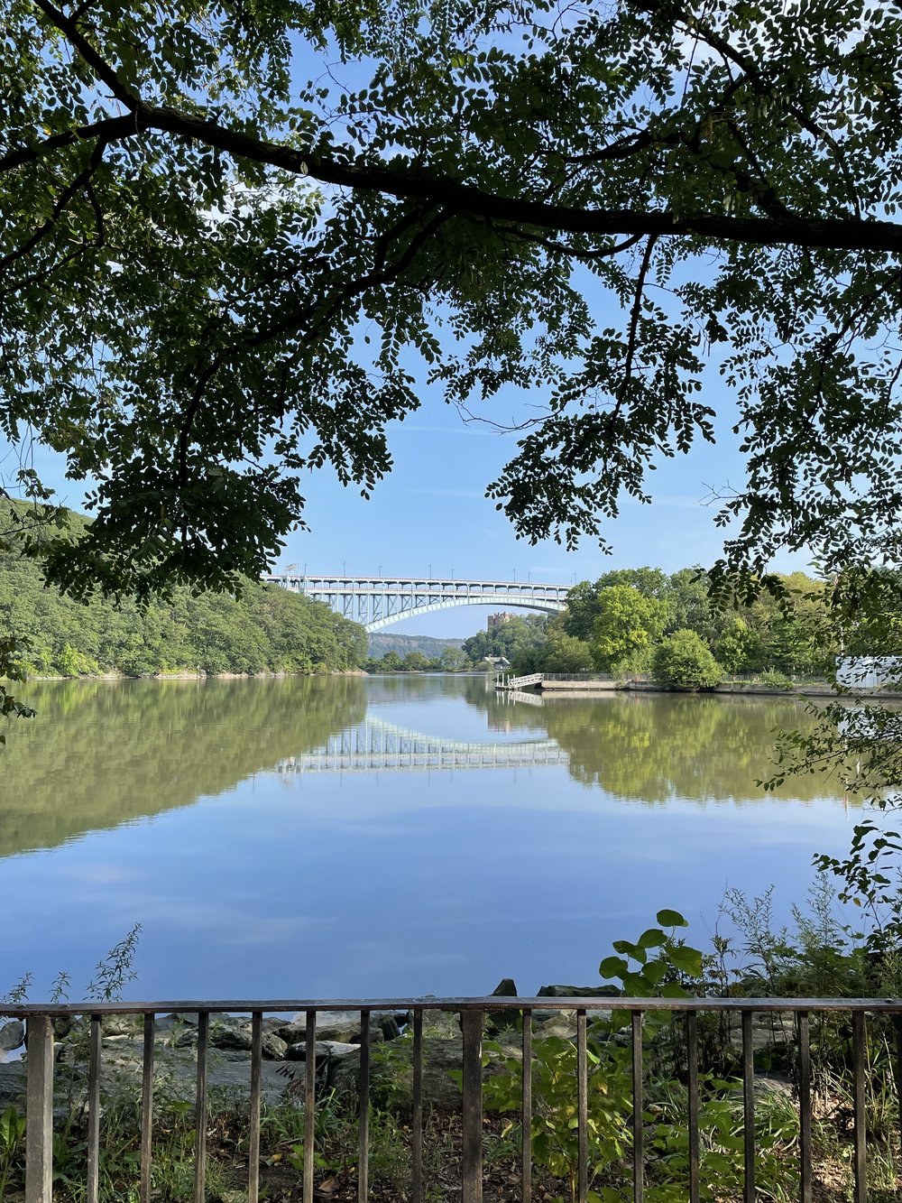 a view of henry hudson bridge from the park nearby