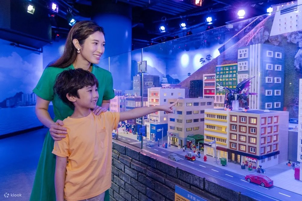 A mom and her son looking at the lego houses