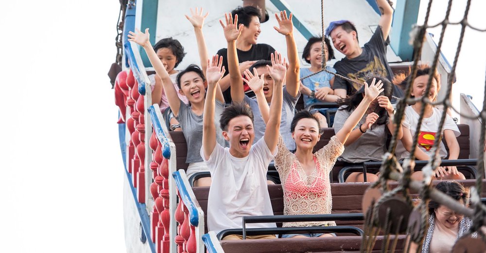 Happy people on a theme park ride