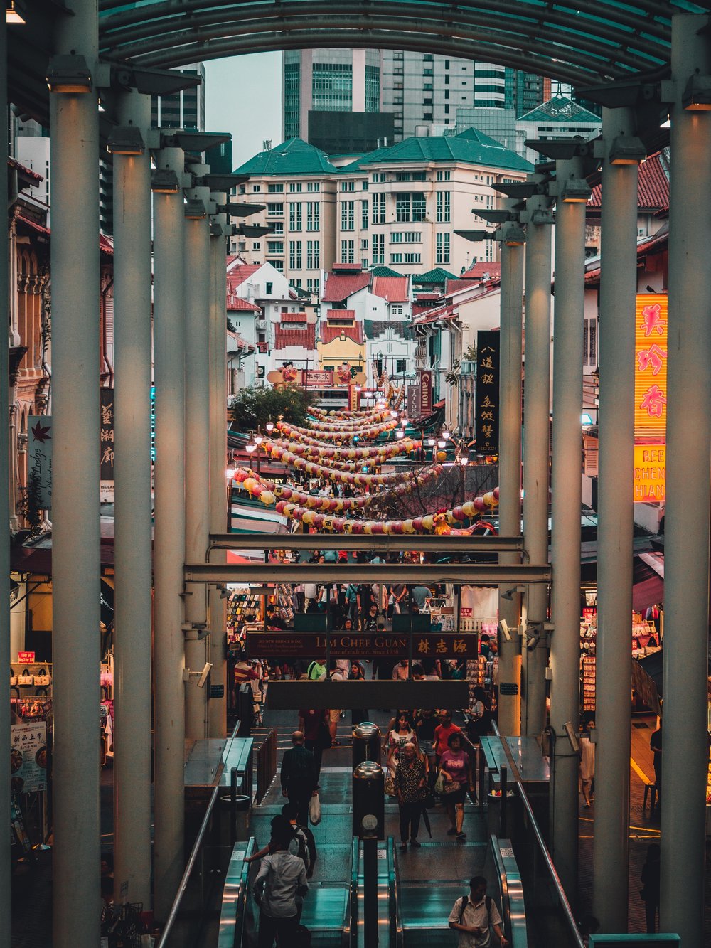 a street full of people in chinatown in singapore