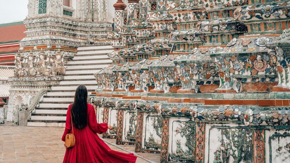 Visit one of the many intricately detailed temples in Bangkok to immerse yourself in the country's beautiful culture. Credits to @travelwithcg on Instagram
