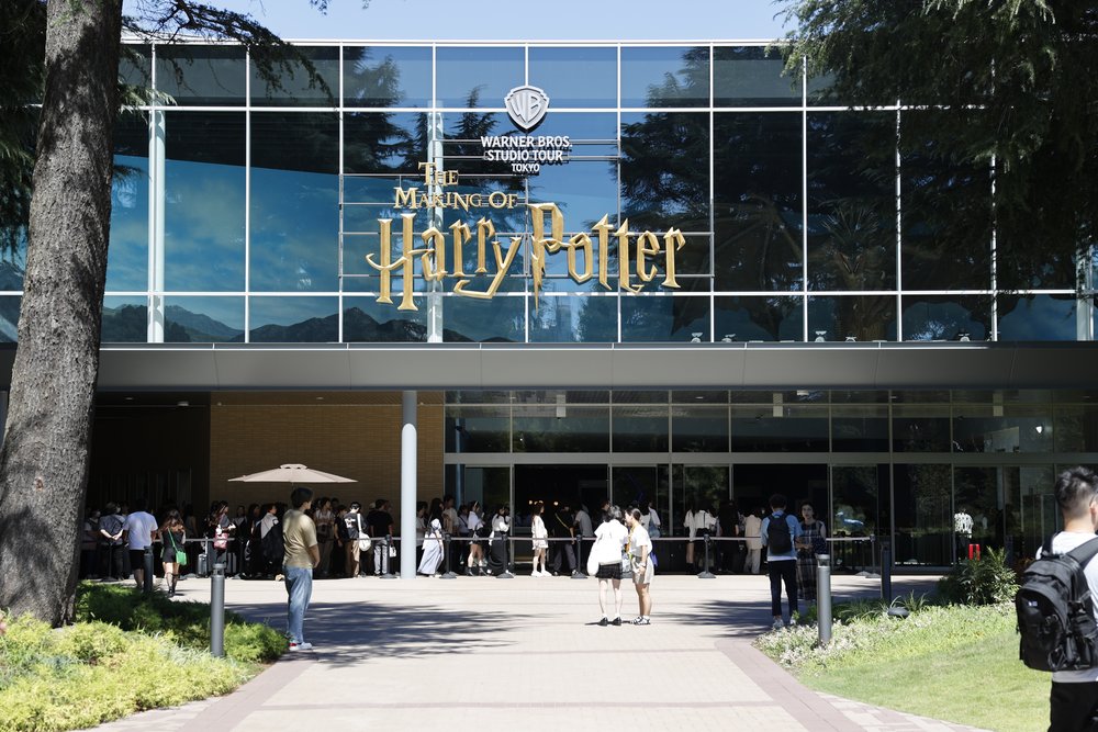 People lining up at the entrance of Warner Bros. Studio building in Tokyo