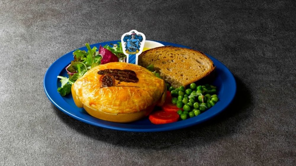 fish pie, peas, carrots, and vegetables on a blue plate