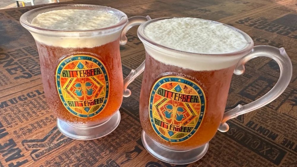 2 glass mugs filled with butterbeer