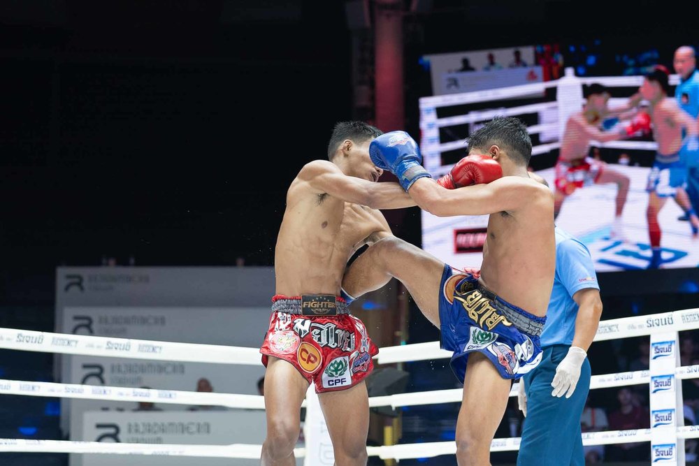 Two men punching and kicking each other