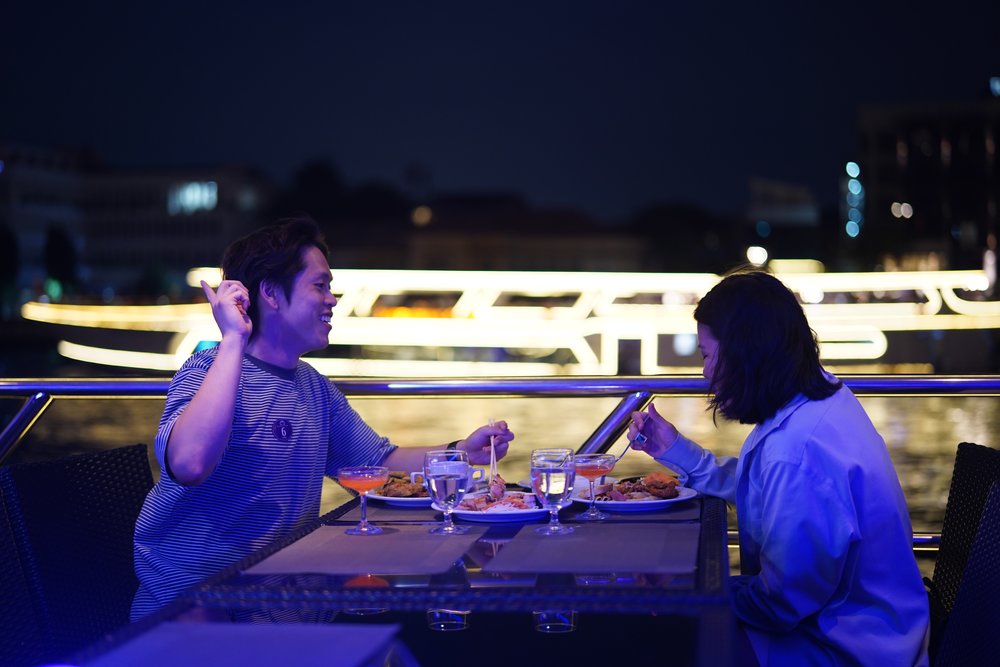 Man and woman eating on a boat