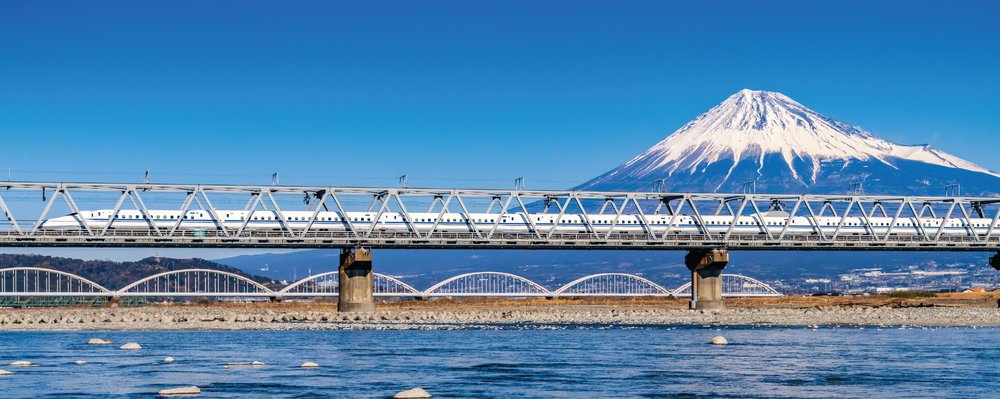 Shinkansen bullet train crossing the Fujikawa Bridge over the Fuji River in Japan