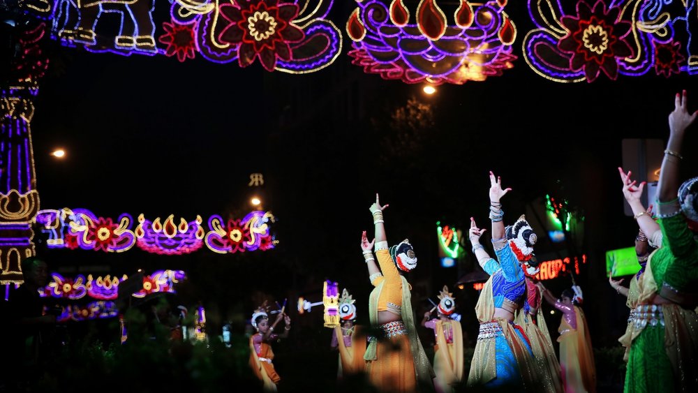 Colorful lights and Indian women dancing.