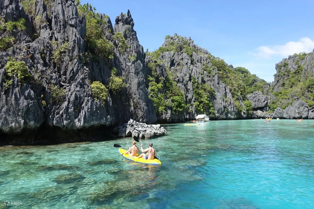 Tourist kayakng in secret lagoon