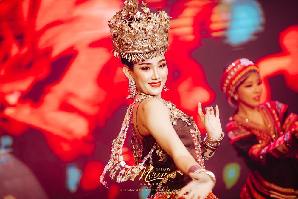 A female performer with a crown on stage