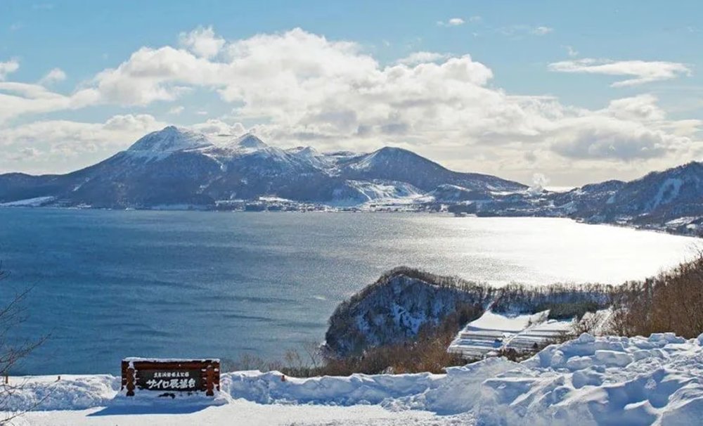 Breathtaking view of lake Toya with snowcapped mountains at the backdrop