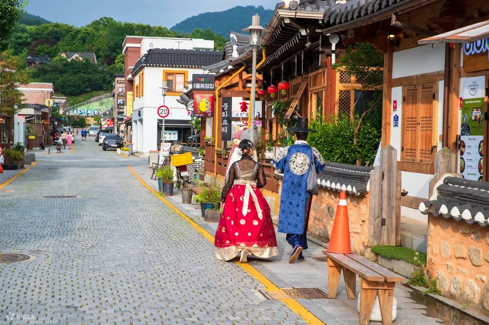 Tourist wearing traditional clothing in Jeonju's bustling market.