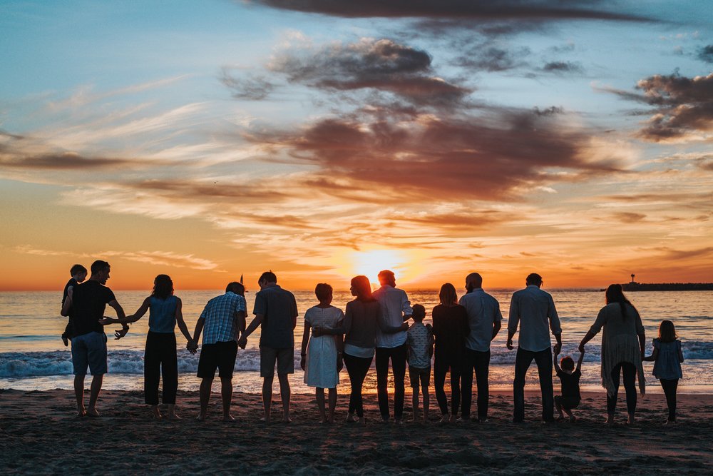 Family in the beach during sunset