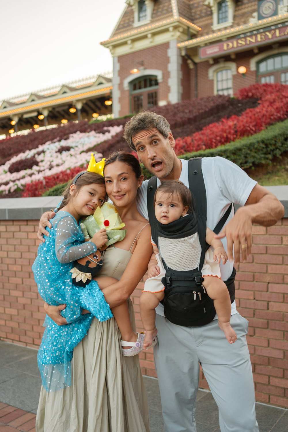 bolzico family behind mickey mouse flowerbed
