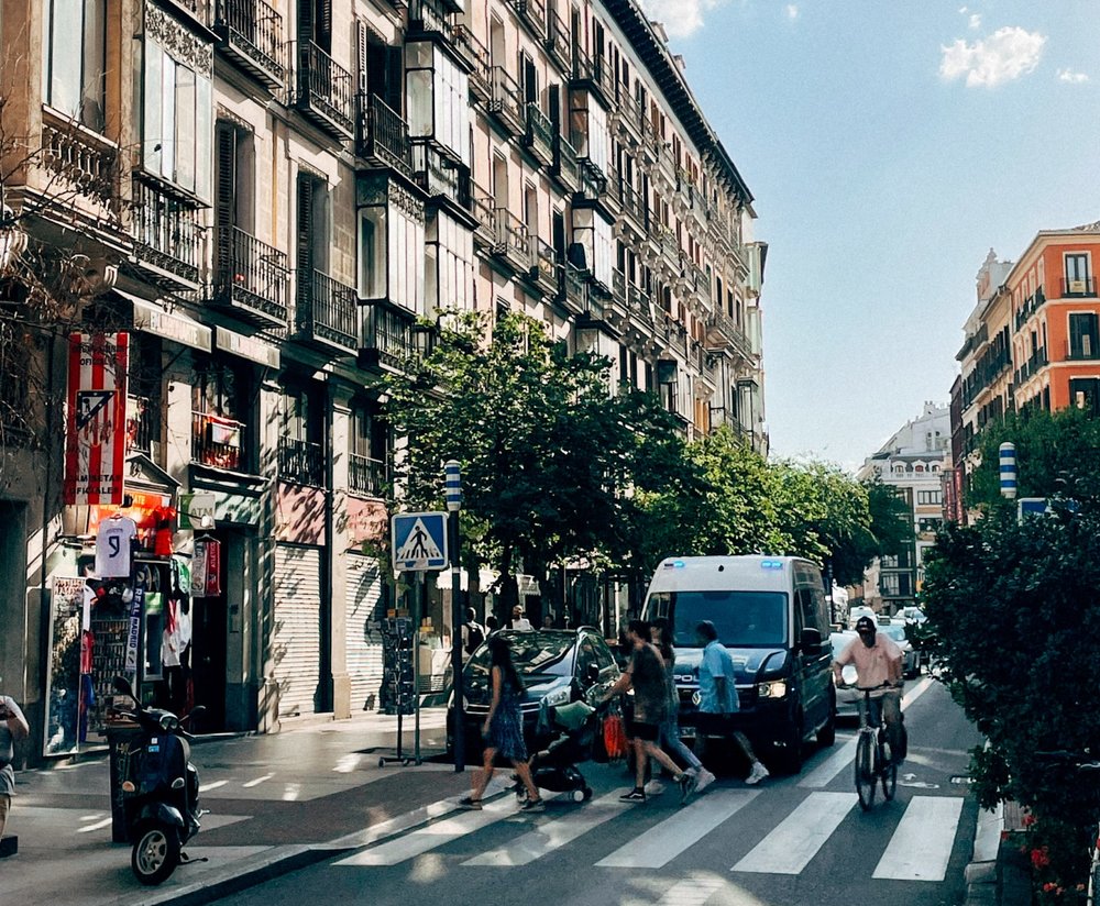 the streets of madrid during the day, bustling with people