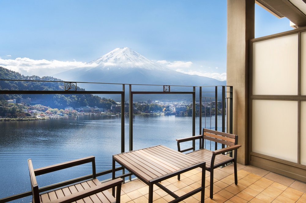 Balcony with chairs and a table overlooking Mount Fuji