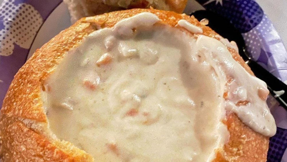 Dive into comfort with Clam Chowder in a warm Sourdough Bowl at Disneyland! Image credits to @aleeexlovesfood on Instagram.
