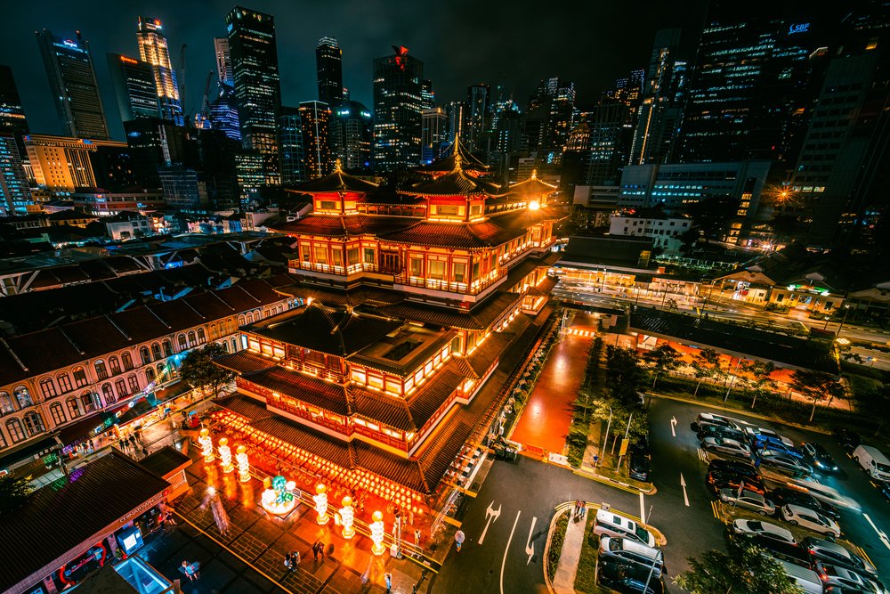 an aerial view of chinatown in singapore during the evening with lights on