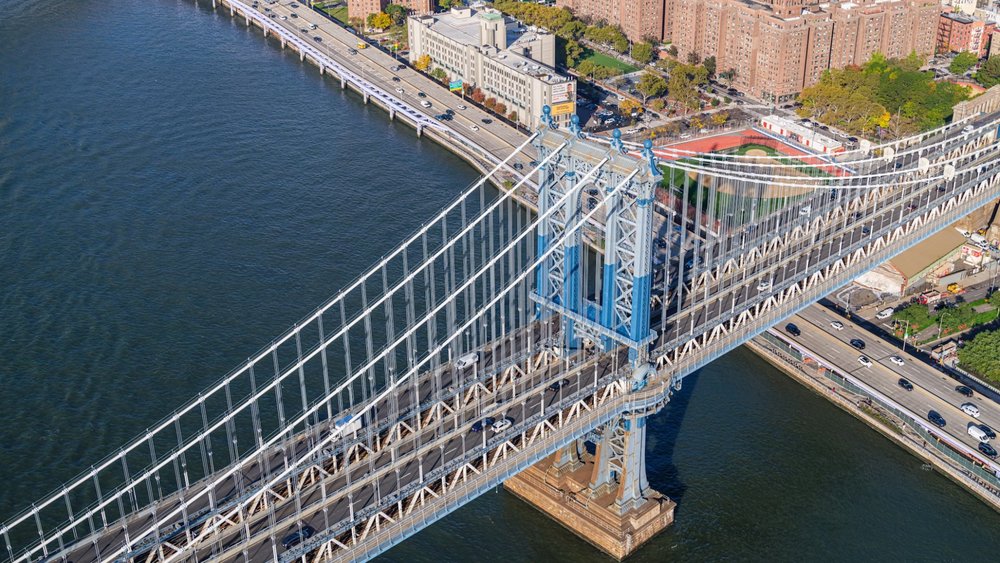 Explore the skies over bridges and buildings in New York! Credits: Lumin Osity on Unsplash