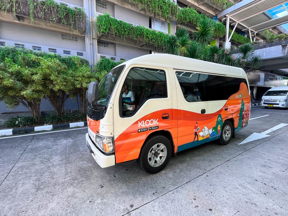 a van private car charter with Klook decals