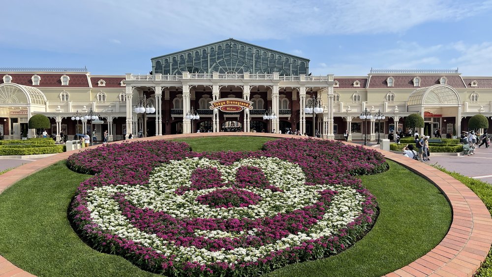 tokyo disney with a huge mickey mouse shaped with flowers