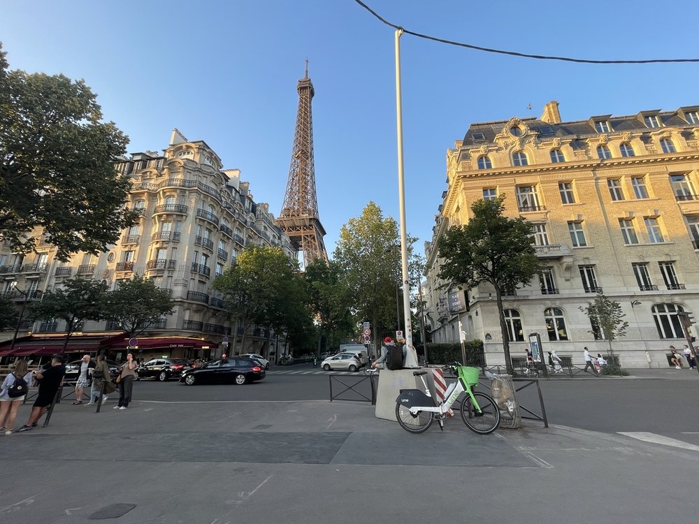 paris with the sun setting and eiffel tower in the background