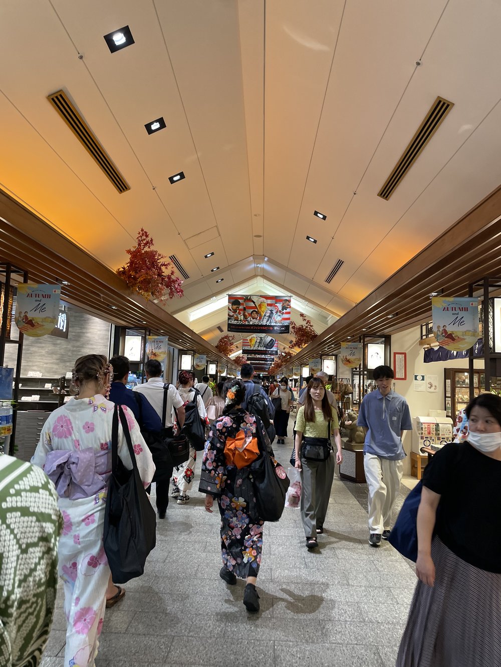 people wearing kimonos while walking in slightly crowded area