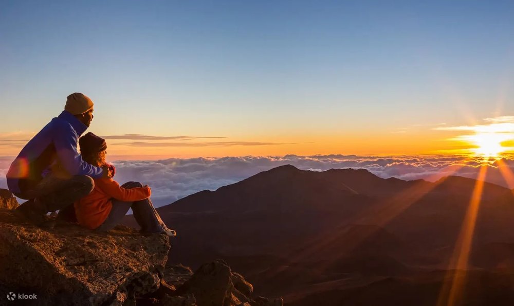 Couple watching sunset in Mount Agung 