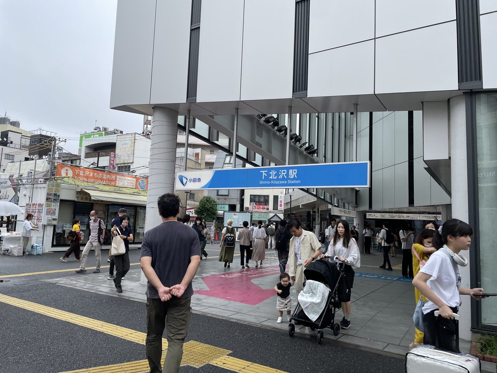 right outside shimokitazawa station with signage 