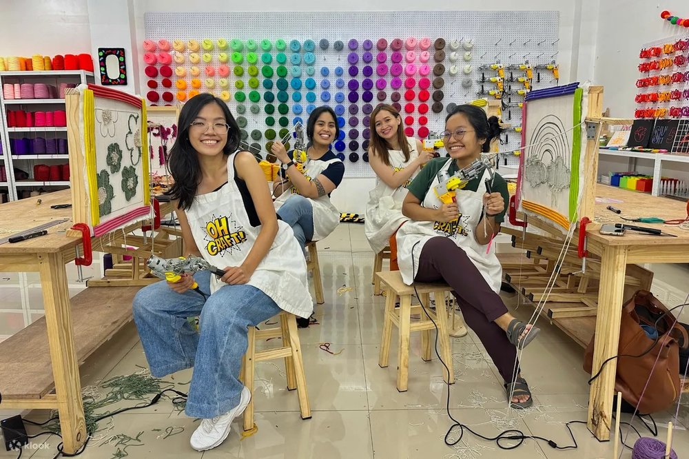 A group of girls doing rug tuffing