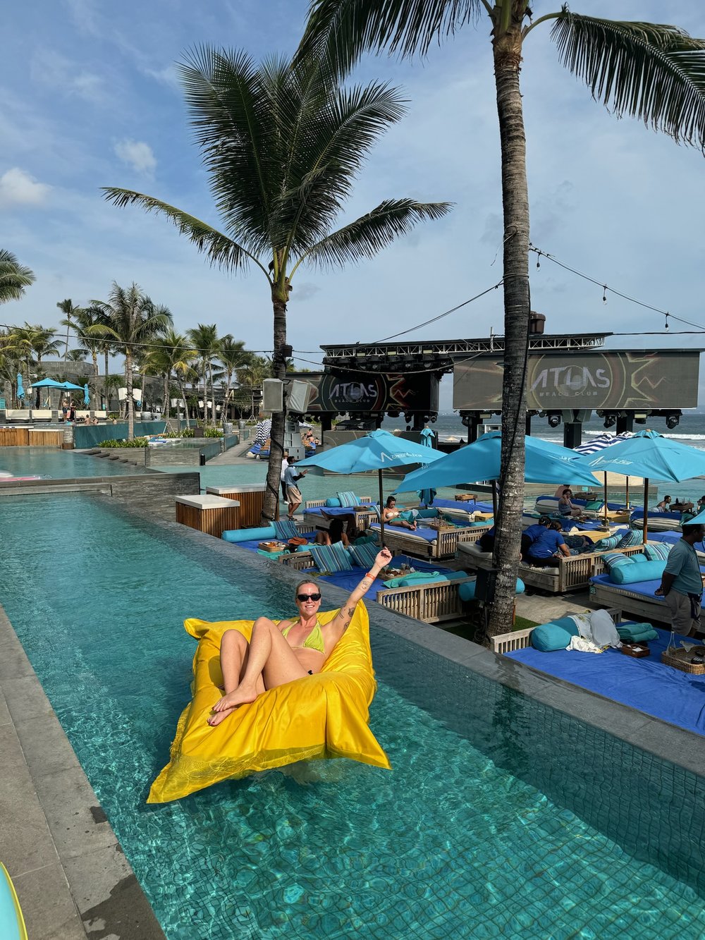 person on a floatie in atlas beach club pool area