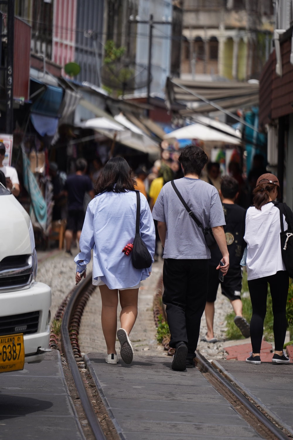 people walking on maeklong railway market