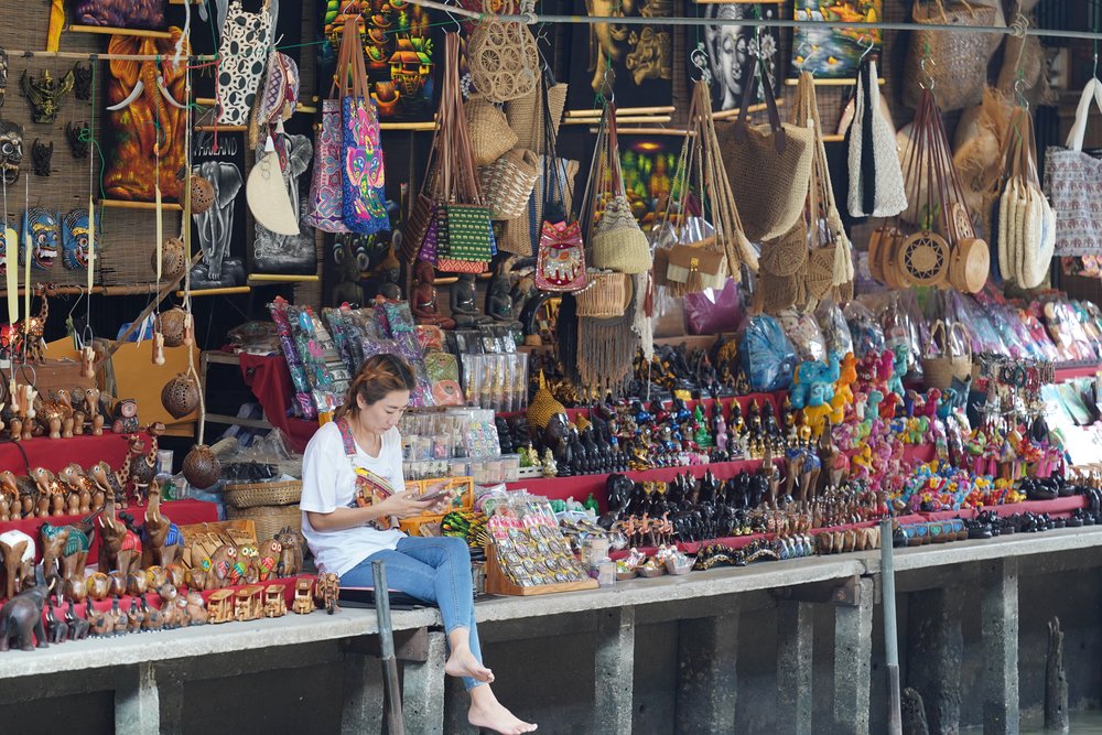 girl sitting at floating market