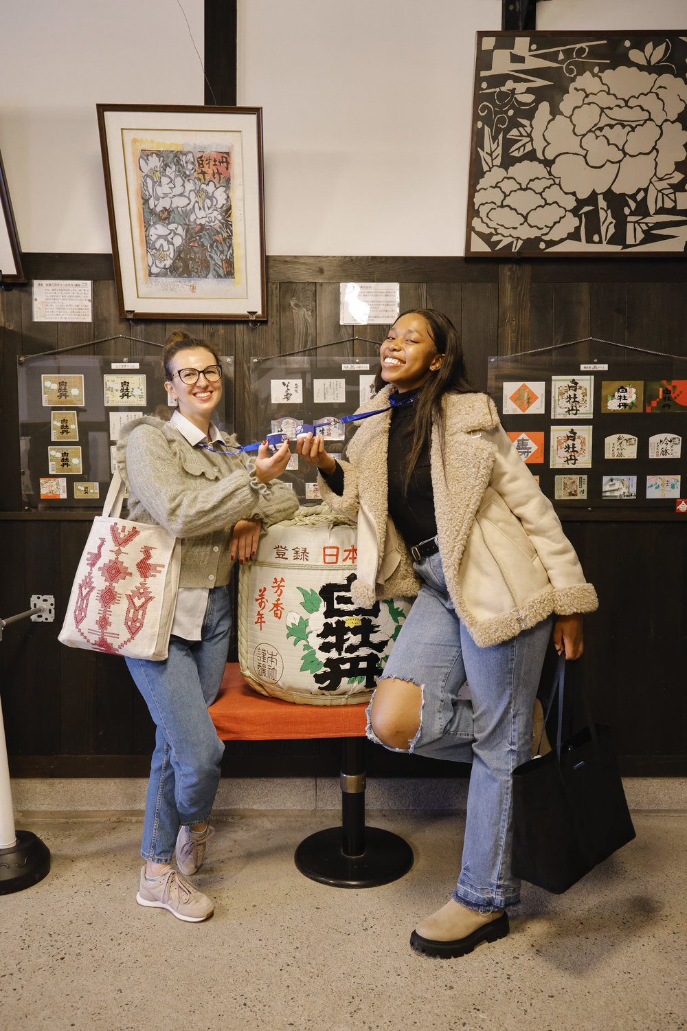 two people posing in a sake brewery in hiroshima