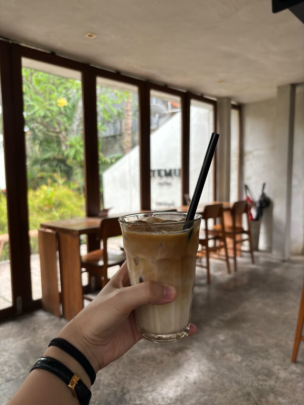 seminyak - person holding iced coffee