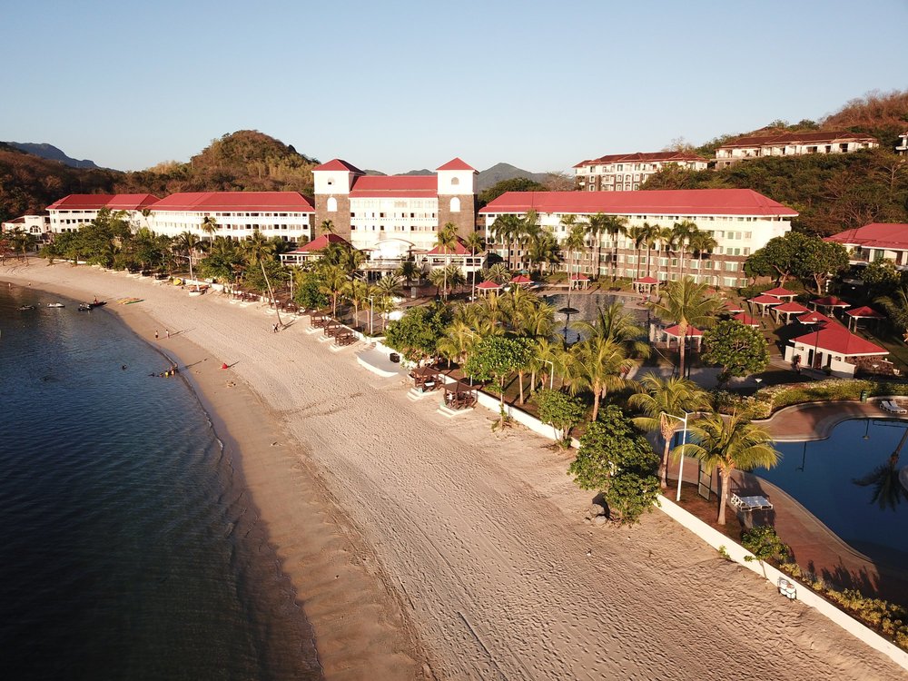 A stretch of beach in front of a hotel