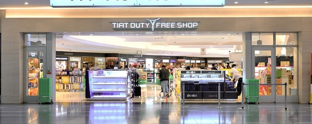 A brightly lit exterior of the Tiat Duty Free Shop at Haneda Airport