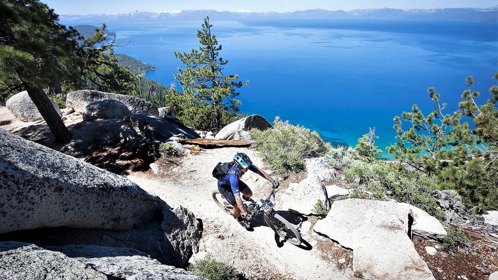 person biking on the flume trail by the edge in nevada