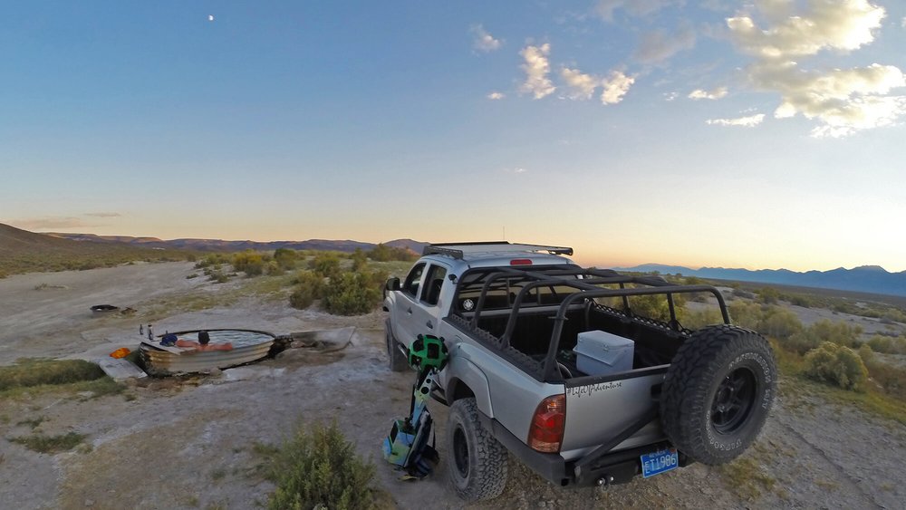 a pick-up track parked alongside a hot spring pool