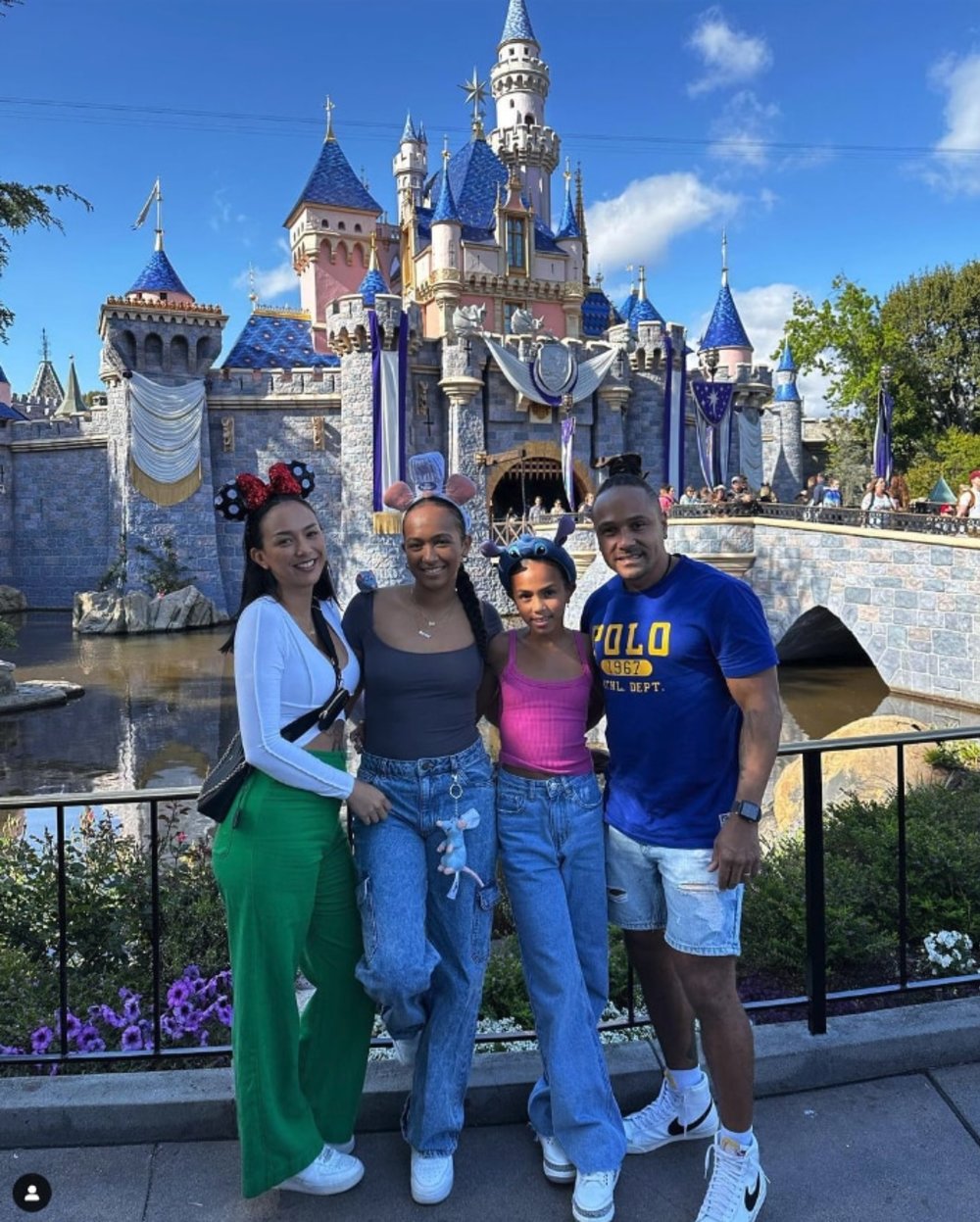 klook australia - kat and deja clark and family posing with the famous disney castle