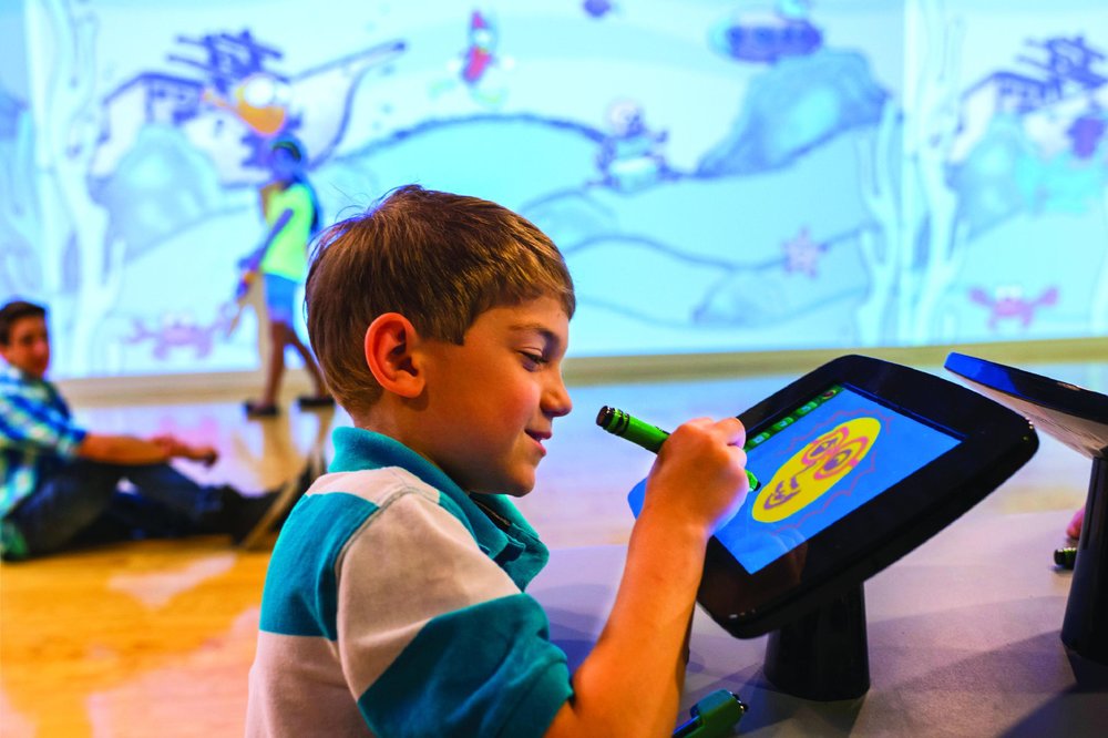 boy drawing in Crayola Experience