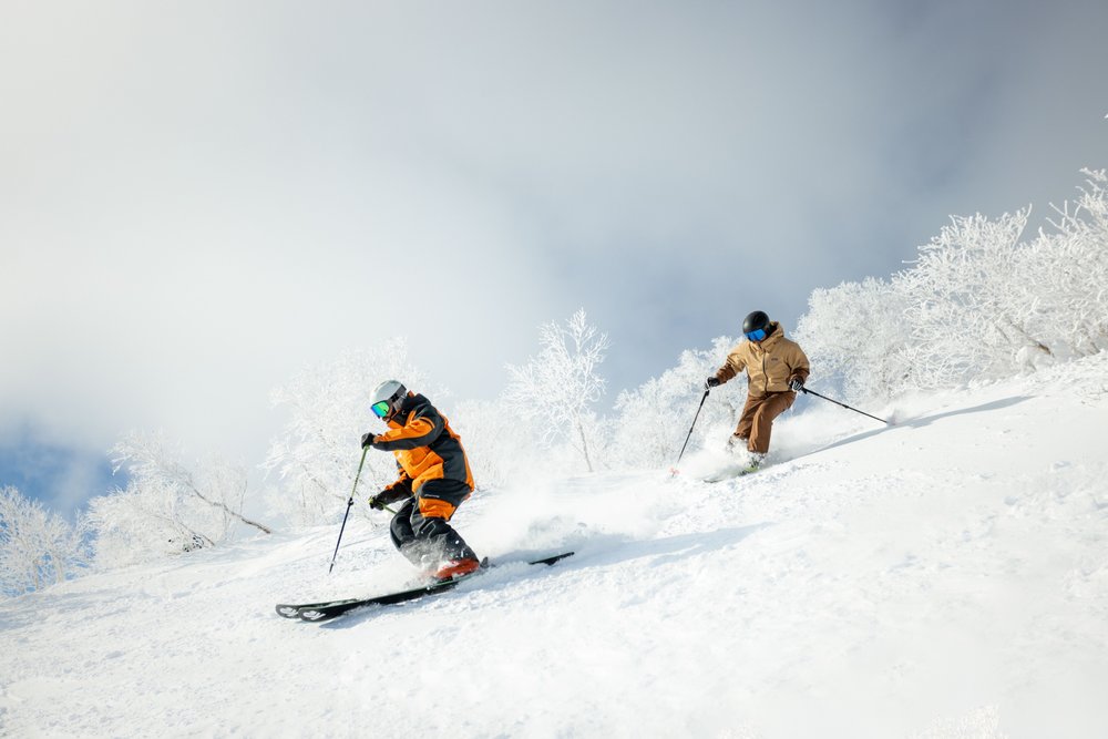 two people skiing down a mountain