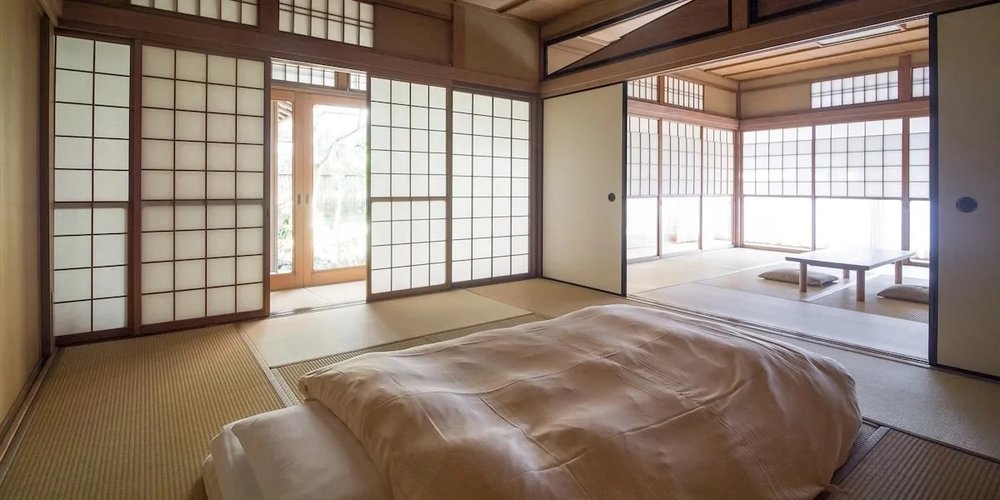 Traditional Japanese room with tatami mats and futons