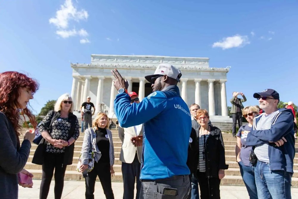 people talking in front of a white building