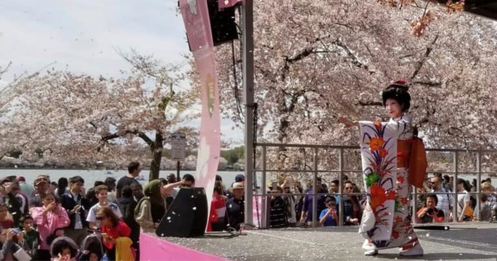 Woman performing on stage in front of a crowd