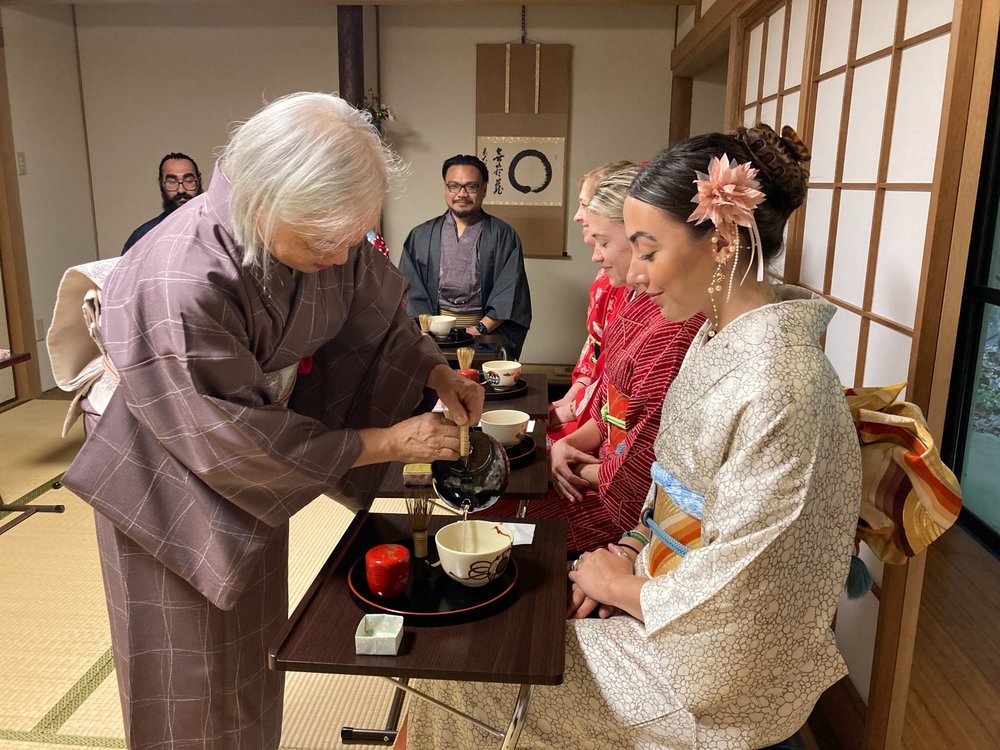 A tea ceremony with people in kimonos