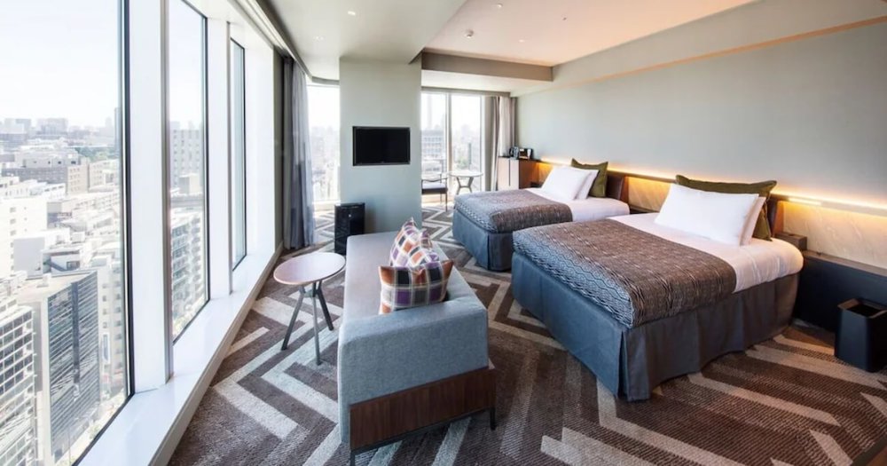 two beds facing large windows