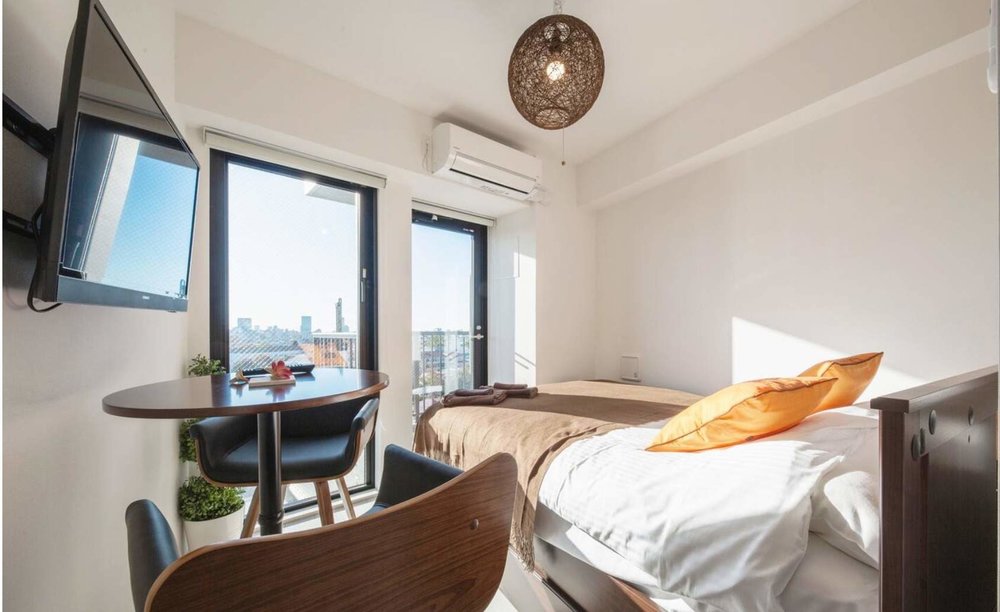 white room with bed and sunlight