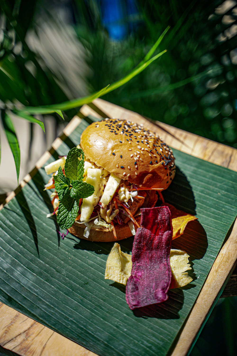 burger with a green placemat and purple flower