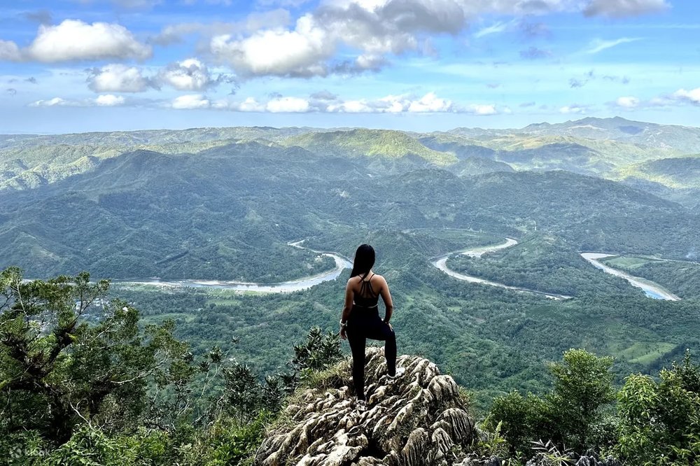 Girl standing on top of a rock